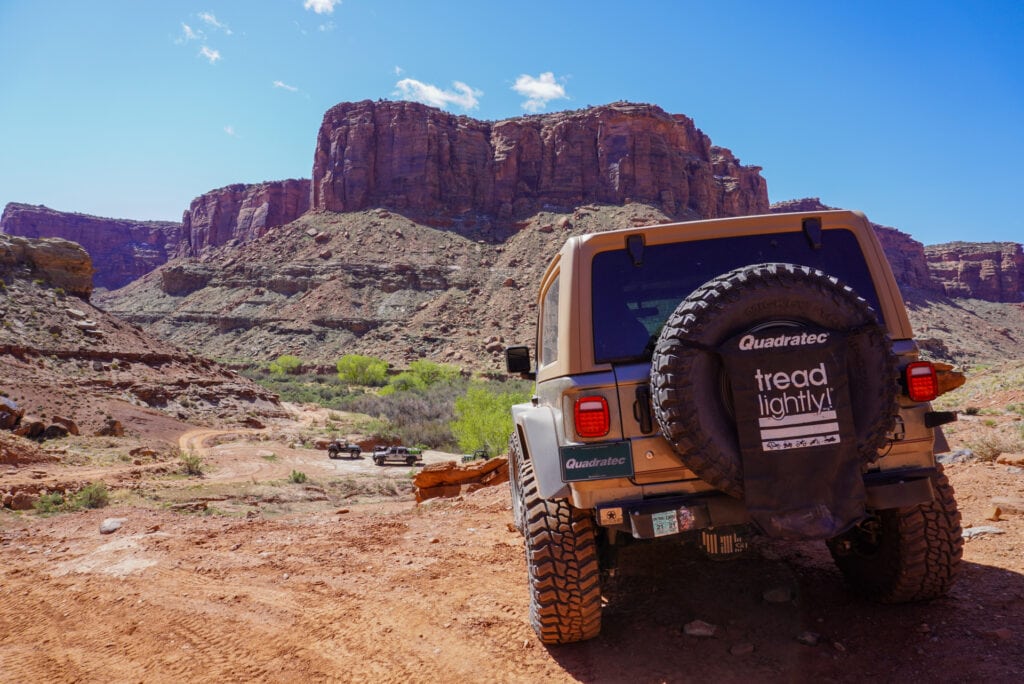 A Jeep parked in a red rock desert landscape