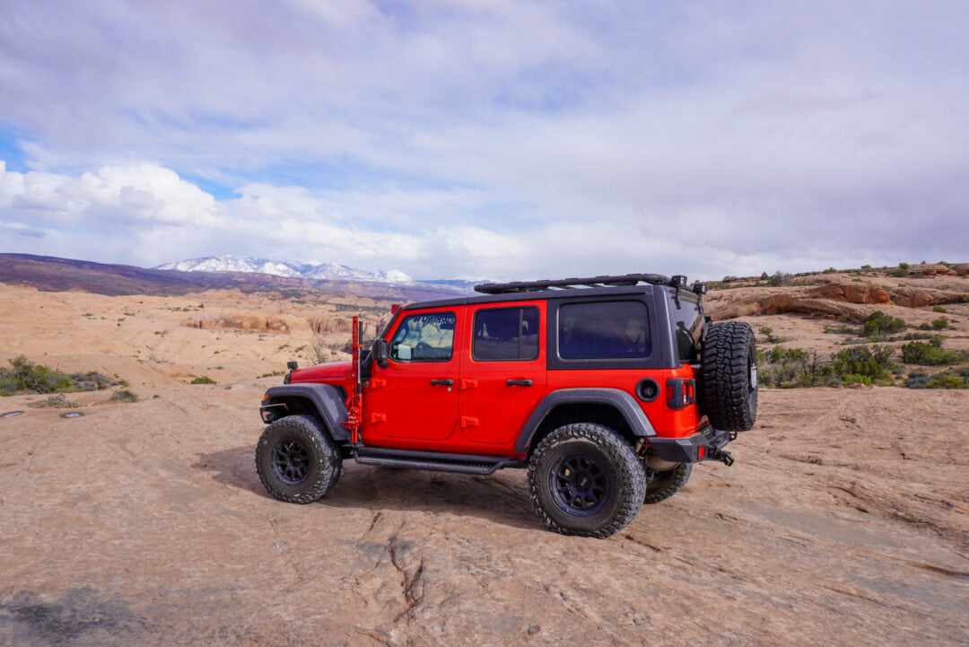 Red Jeep on a rocky desert surface