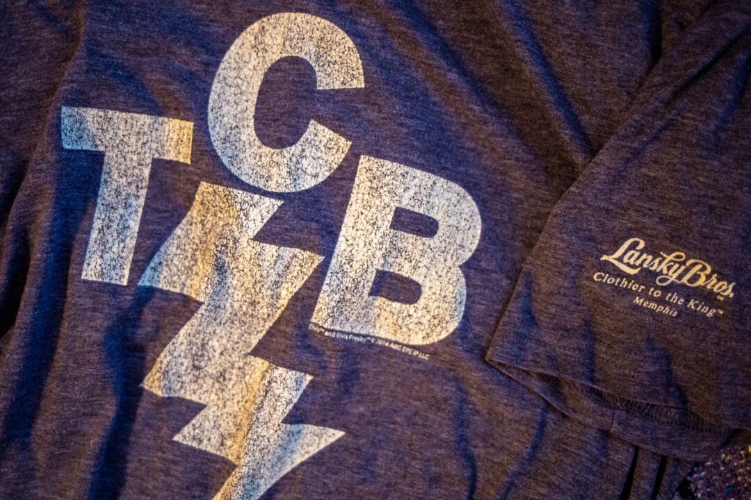 a gray t-shirt that says TCB