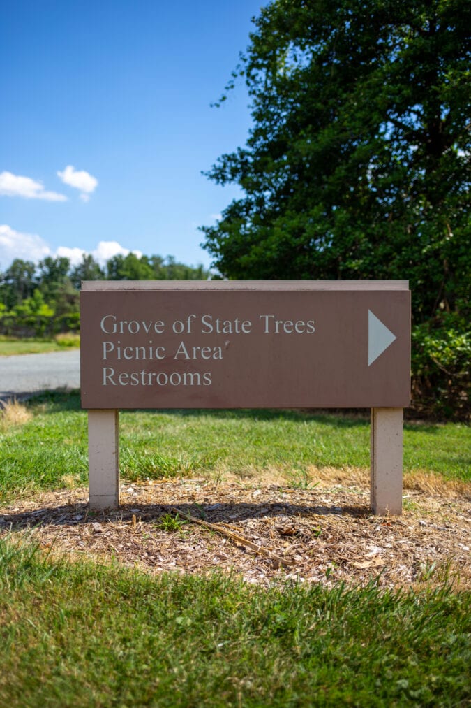 a sign that says "grove of state trees picnic area restrooms"