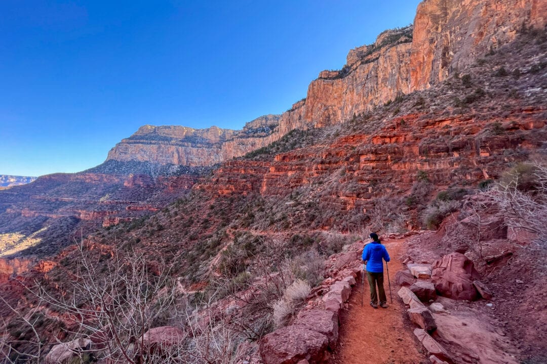 a woman hike through the red rocks of grand canyon national park