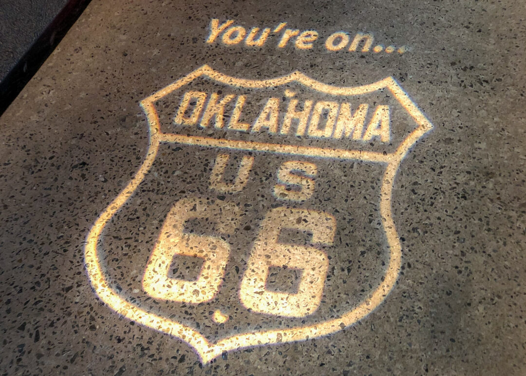 a projection on a piece of pavement of the route 66 shield from oklahoma