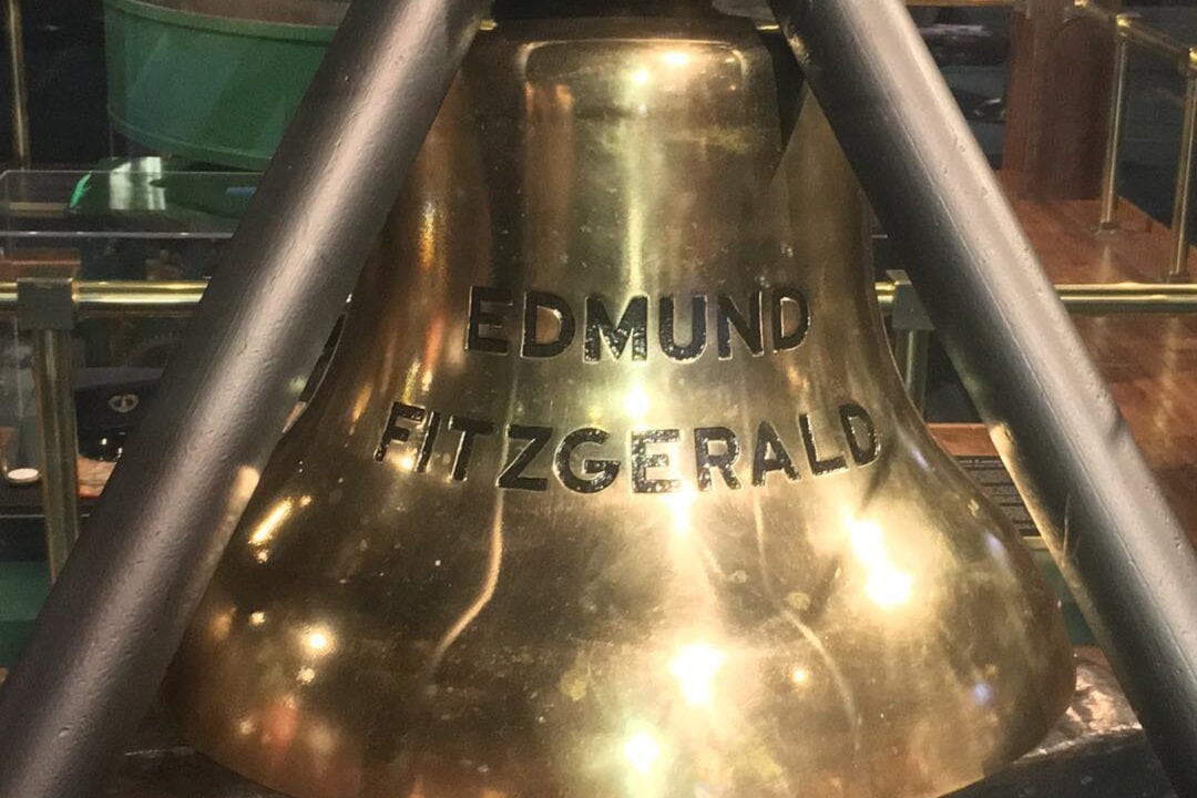 a gold bell embossed with the words edmund fitzgerald