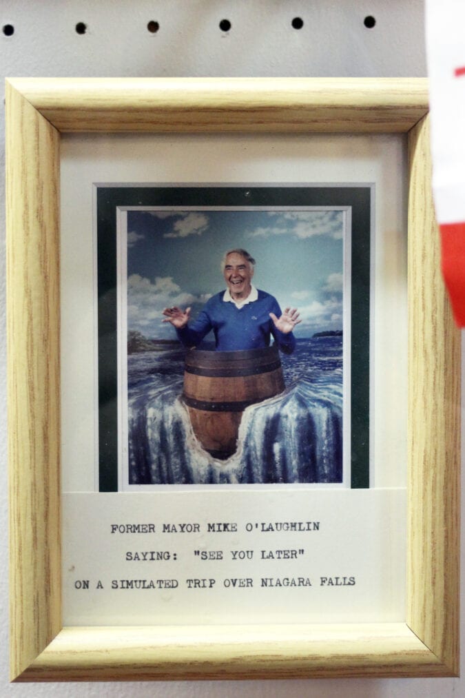 A framed picture of a man in a barrel at the edge of a waterfall, with the text "Former mayor Mike O'Laughlin saying: 'See you later' on a simulated trip over Niagara Falls"