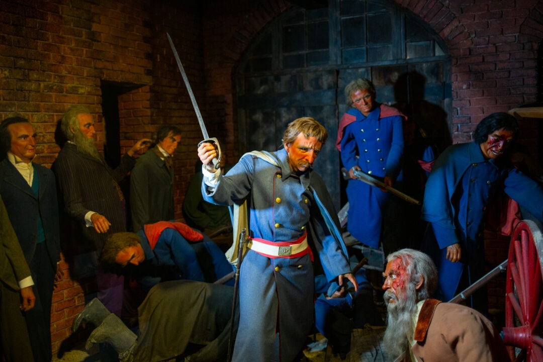 soldiers and a bloodied john brown in a diorama of wax figures