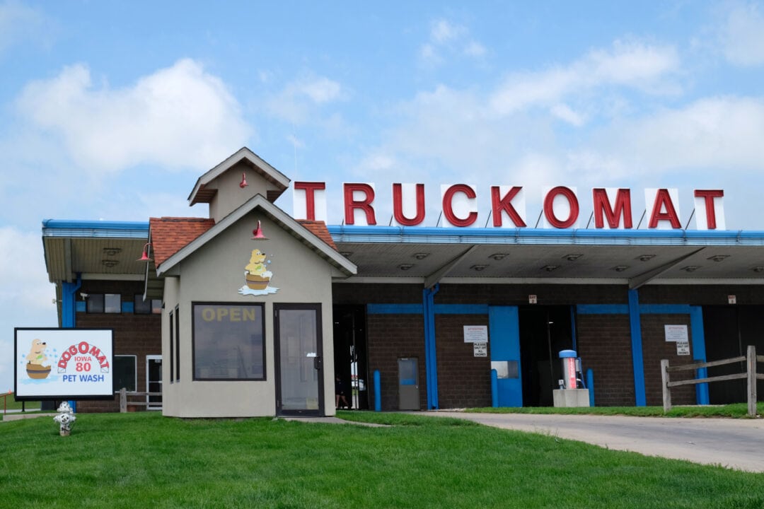 a truck car wash with large red letters saying "truckomat"