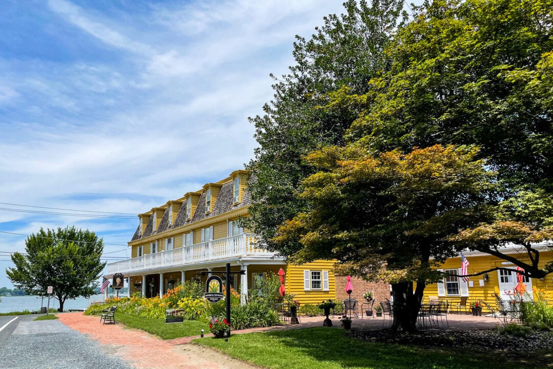 a three-story yellow inn by the water