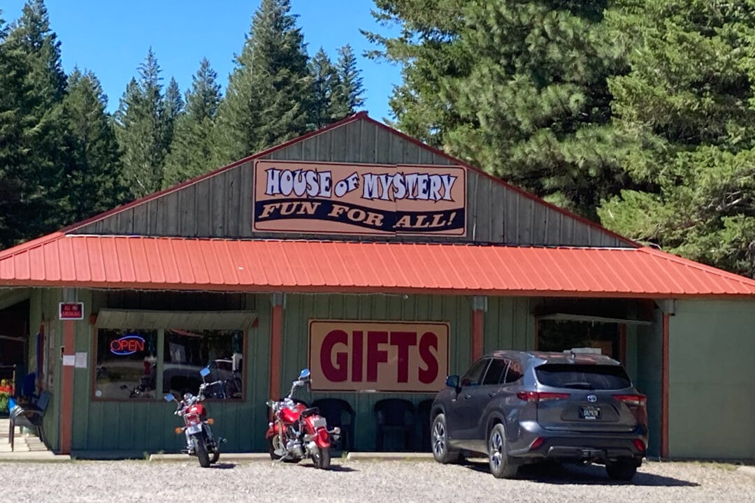 a small green and red building that says "house of mystery fun for all"