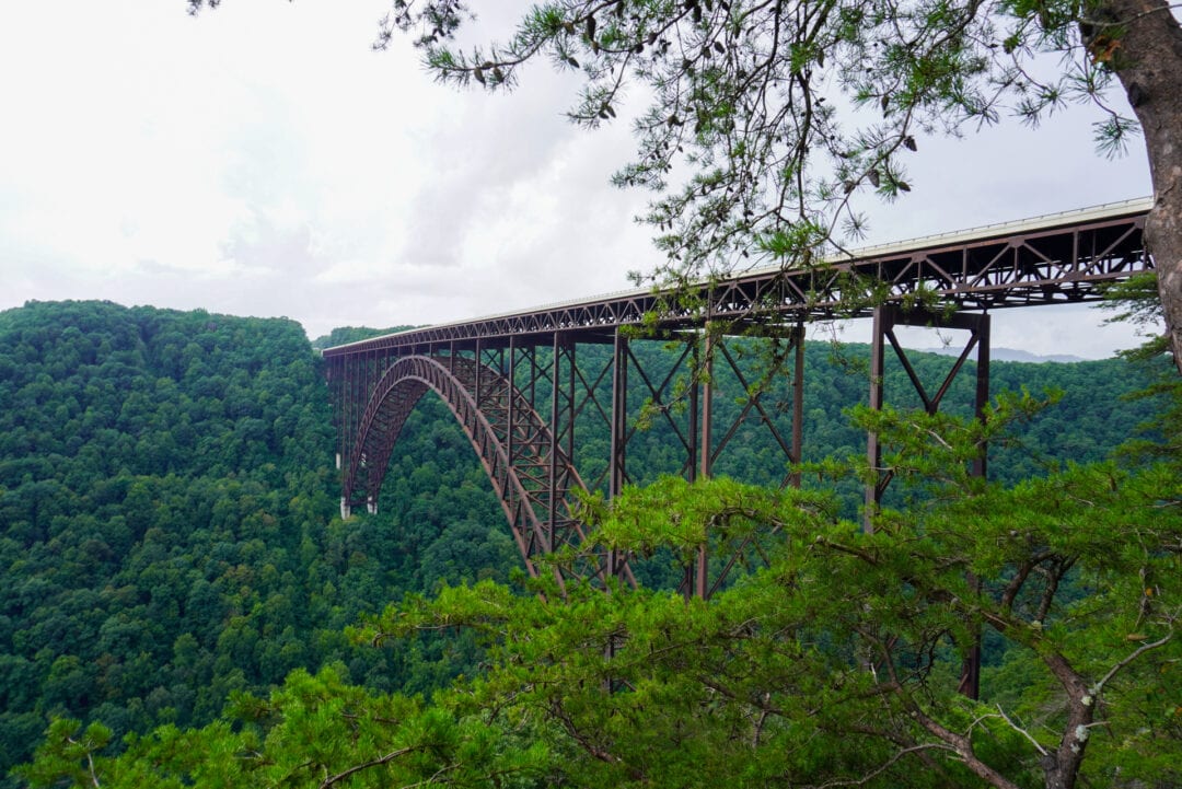 View of a very large arch bridge spanning a lush valley