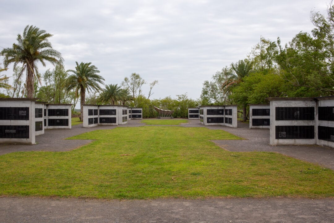 a memorial with granite and metal structures containing names of enslaved workers