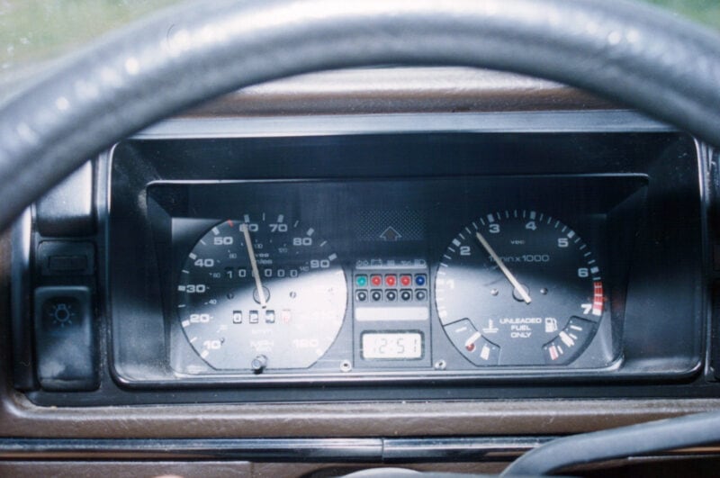 a car's dashboard as seen through the steering wheel