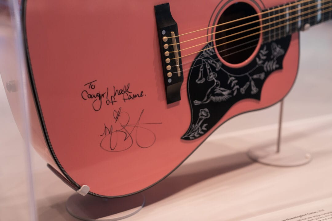 a pink guitar signed by miranda lambert on display