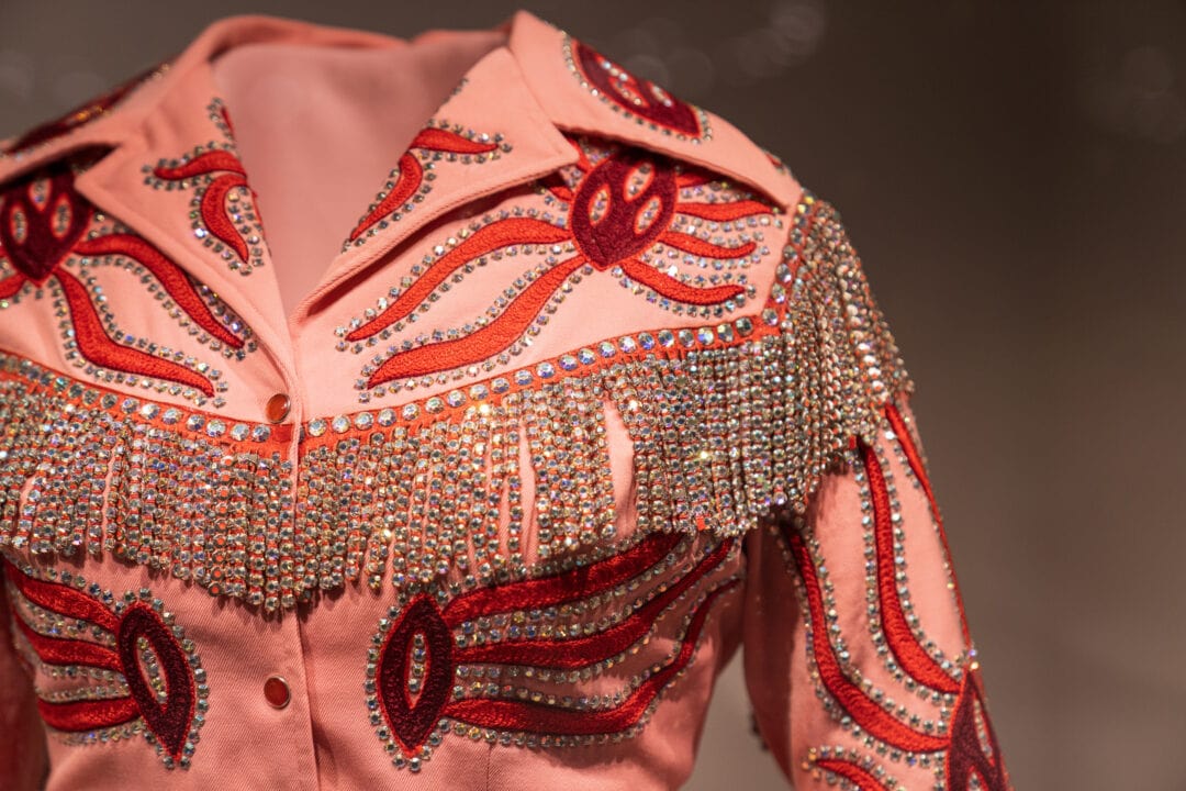 a red and pink suit top decorated with rhinestones and embroidery