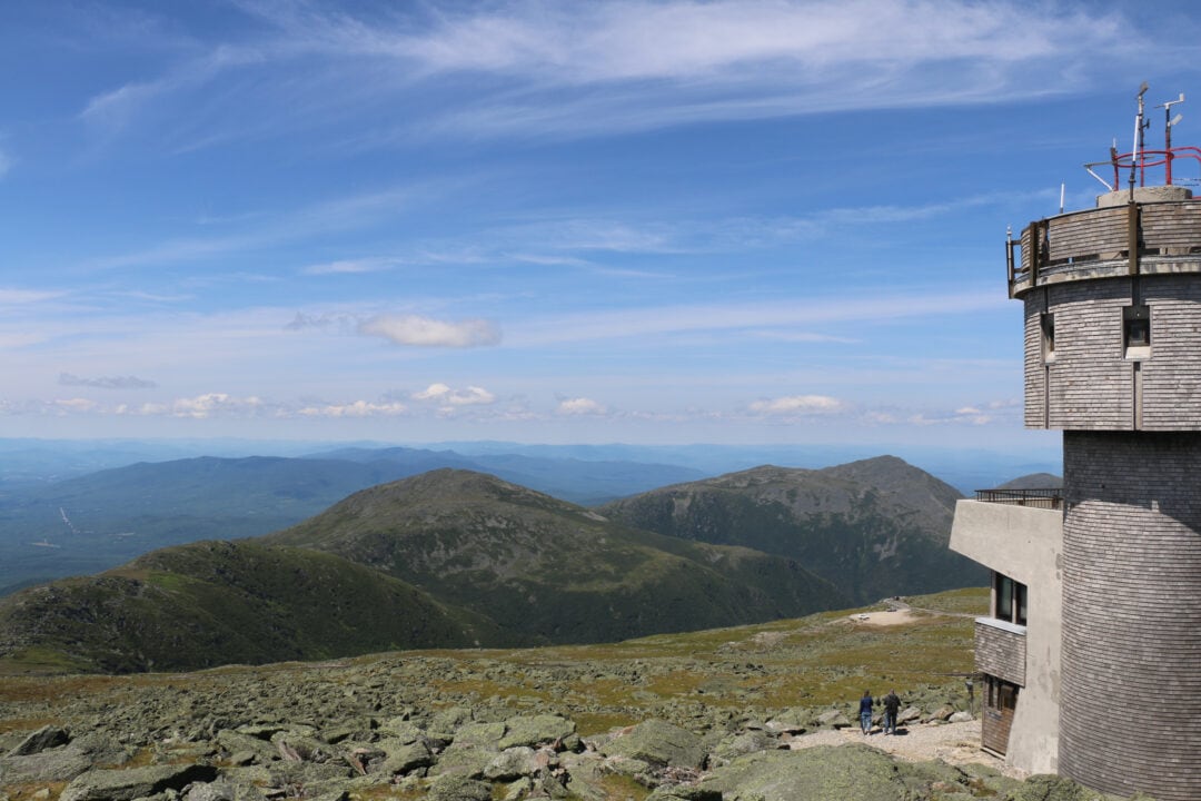 an gray-shingled observatory at the top of a mountain