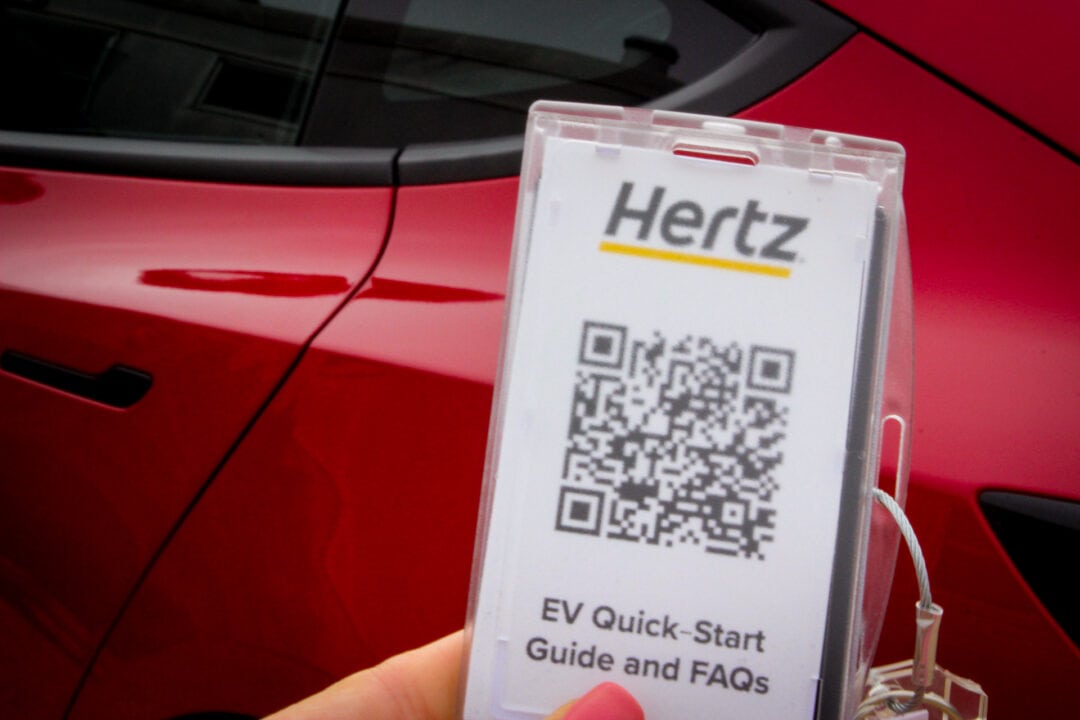 Keyless entry card for rental car showing a QR code to scan for EV quick-start guide and FAQs