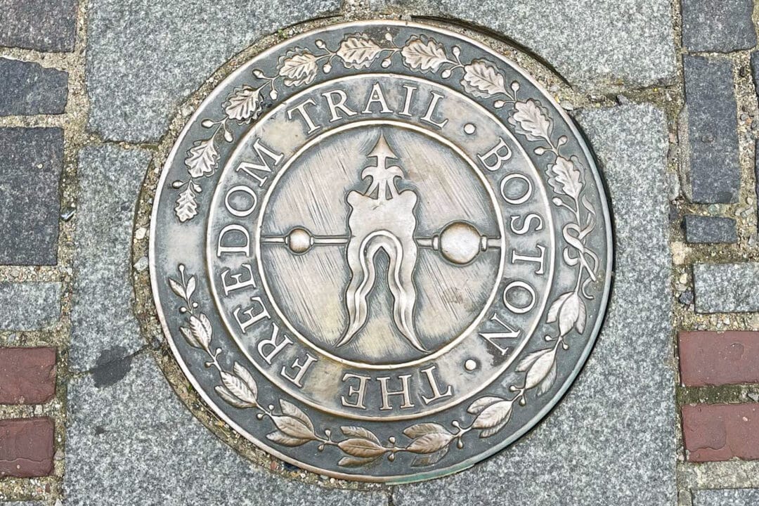 a metal marker on the ground for boston's freedom trail