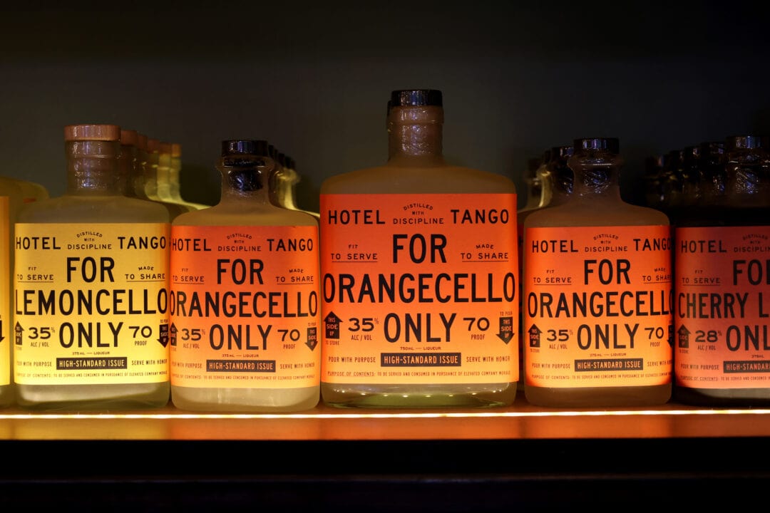 a row of liquor bottles including lemoncello and orangecello