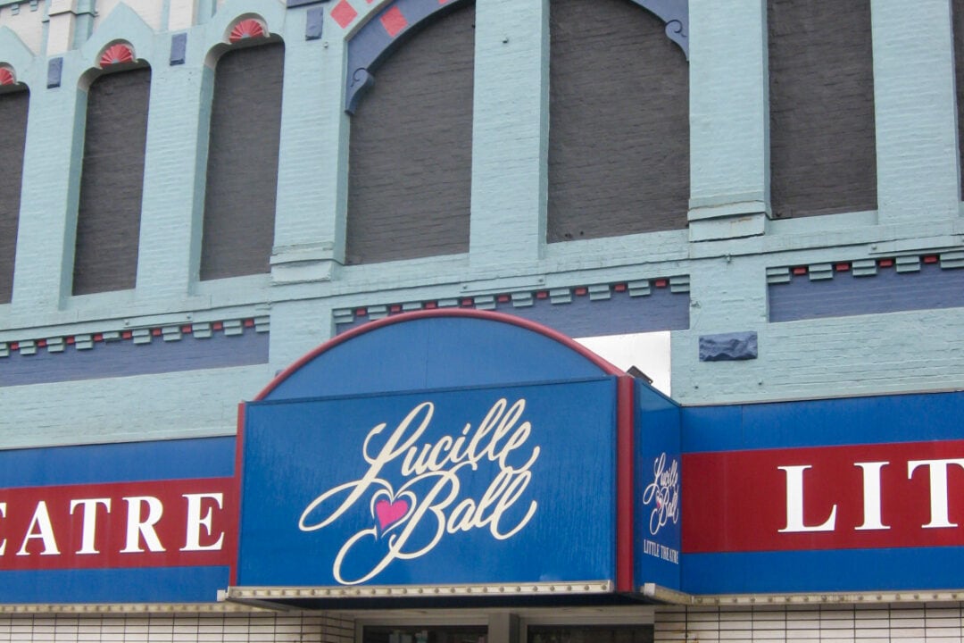 the facade of the lucille ball theater painted in shades of red and blue