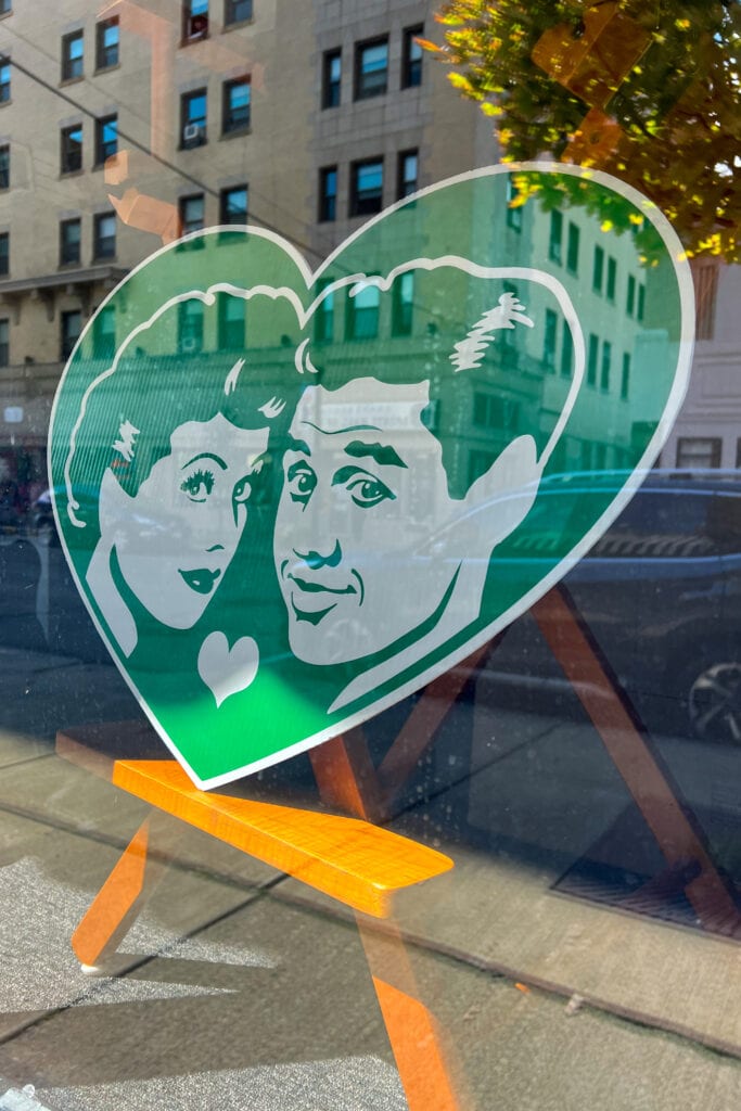 An image on glass displays Lucy and Desi's faces within a heart shaped border.