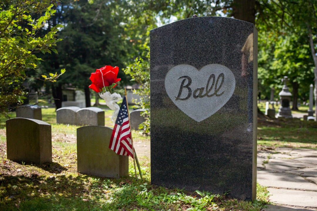 a shiny black marble headstone for the Ball family in a cemetery