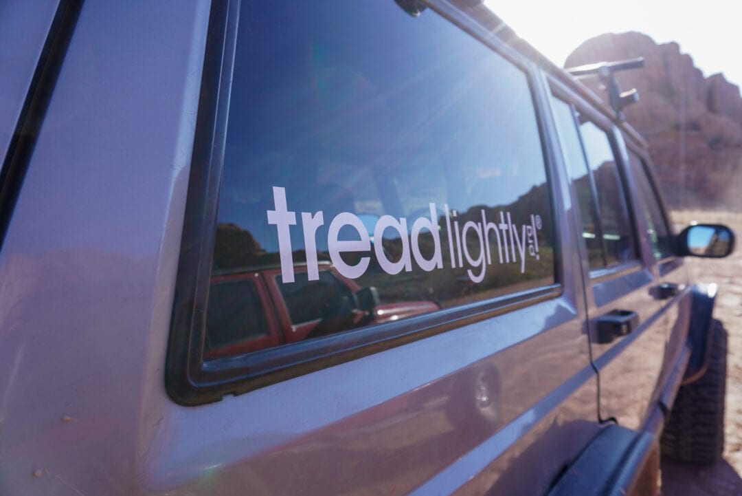 Close-up of a "Tread Lightly" sticker on the window of a car