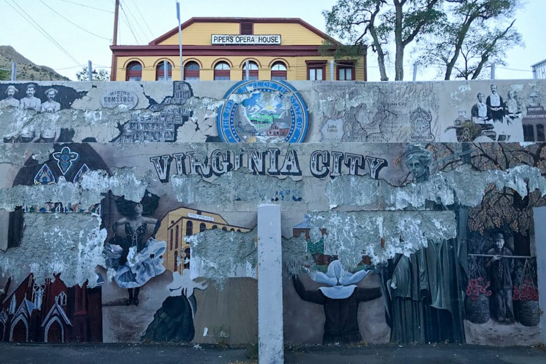 a mural on a wall for virginia city in front of pipers opera house