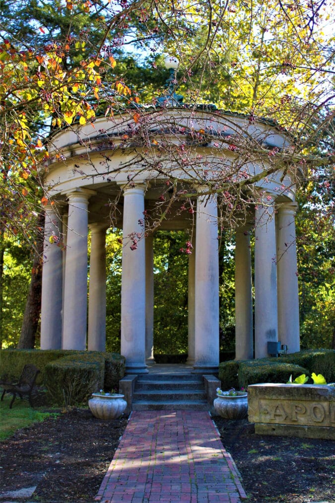 a columned monument outside with a brick path
