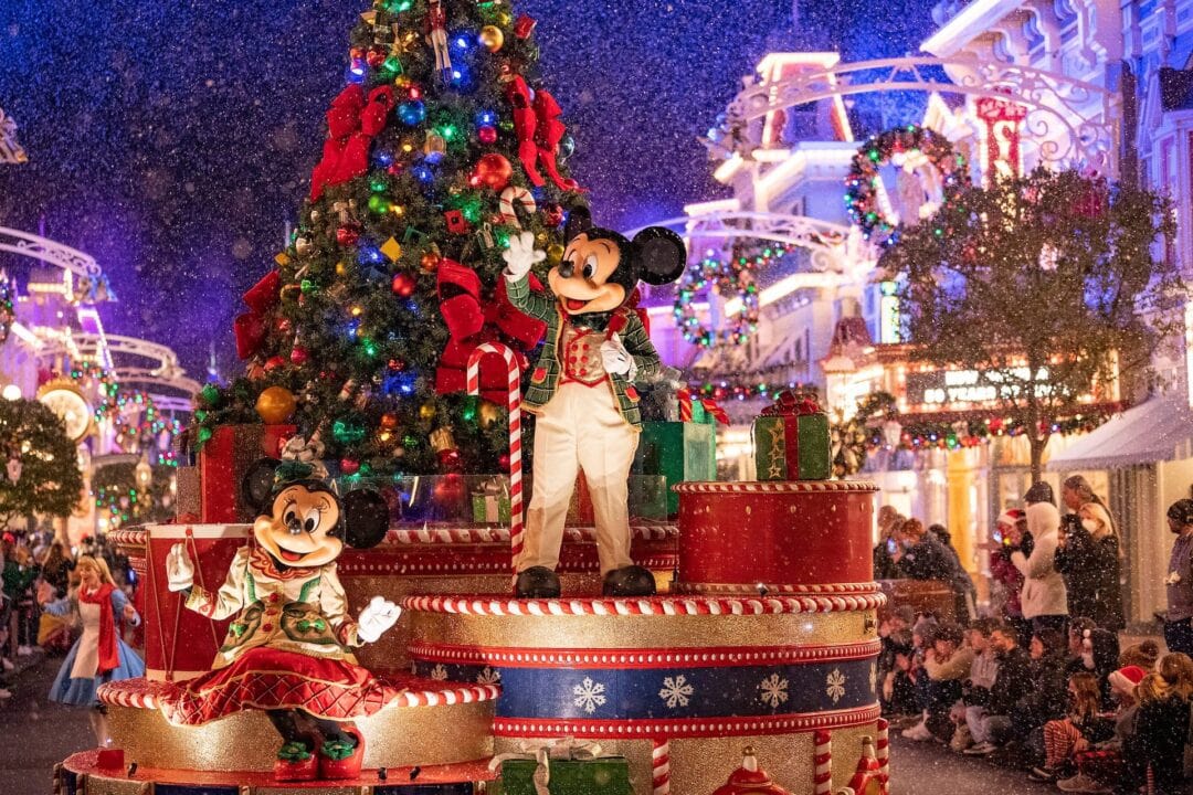 Mickey and Minnie Mouse wave to the crowd at holiday parade in Disney World, Florida.