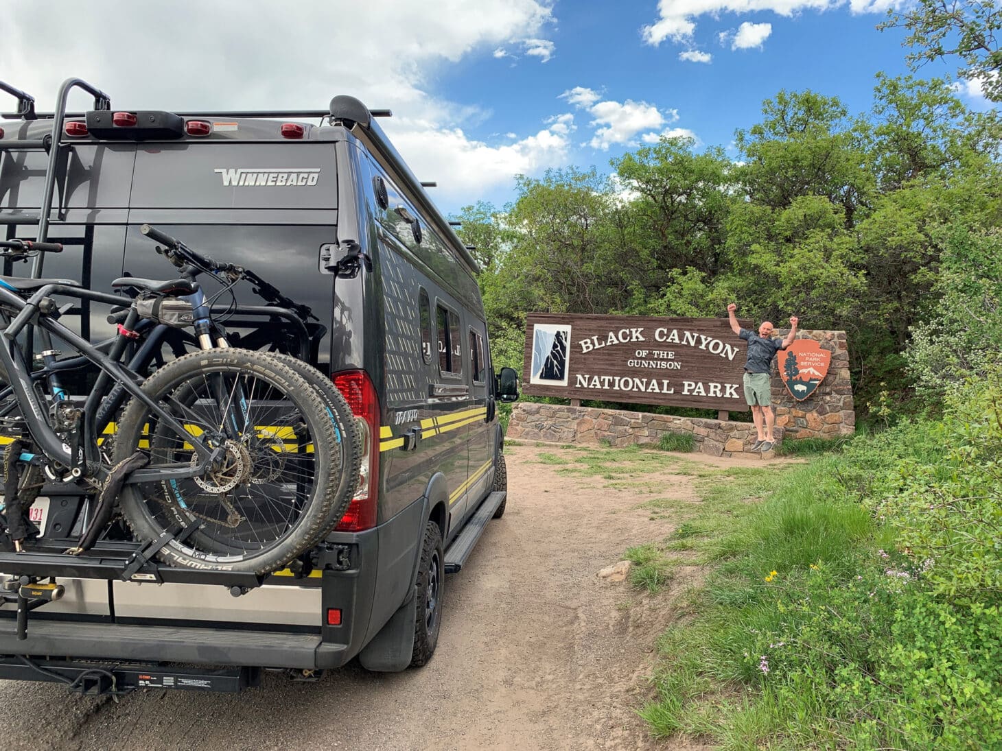 A rugged, black Class B RV stands at the entrance to Black Canyon of the Gunnison National Park in Colorado.