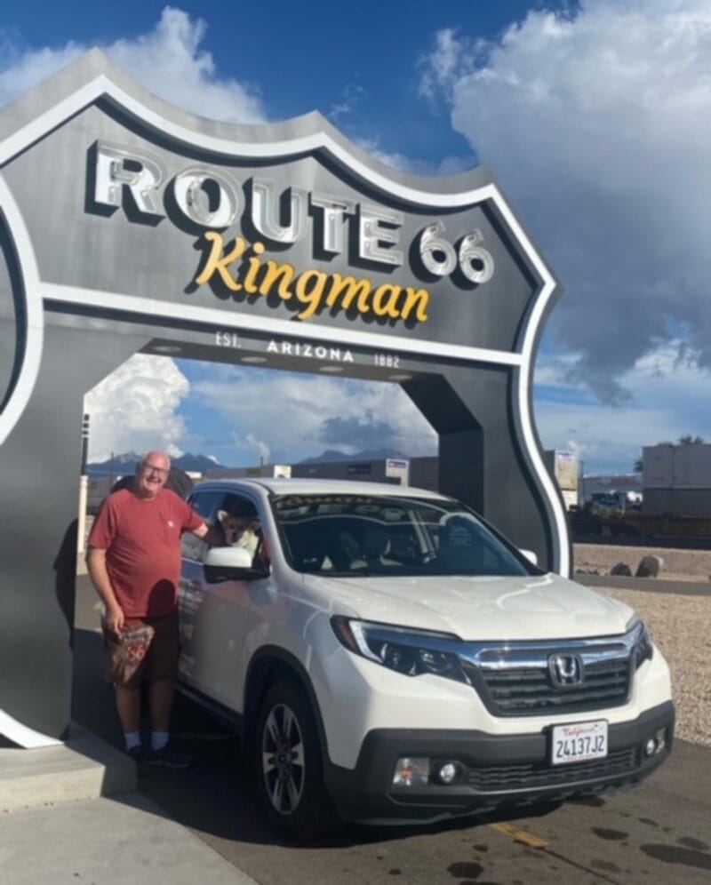 The author and his truck parked beneath a sign for Route 66.