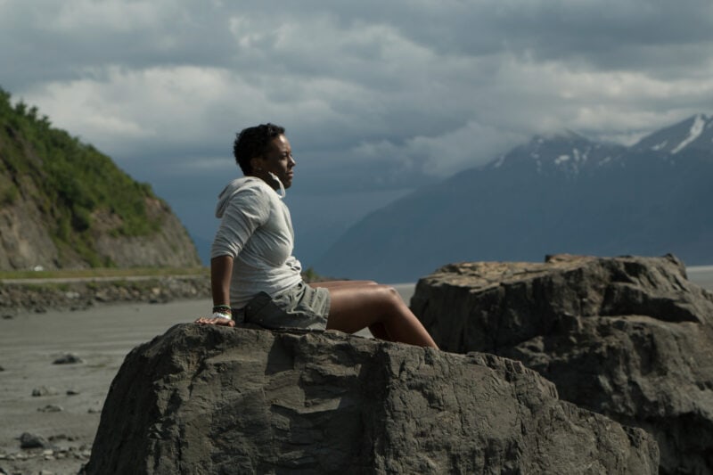 The author enjoys the scenery while perched on a rock.