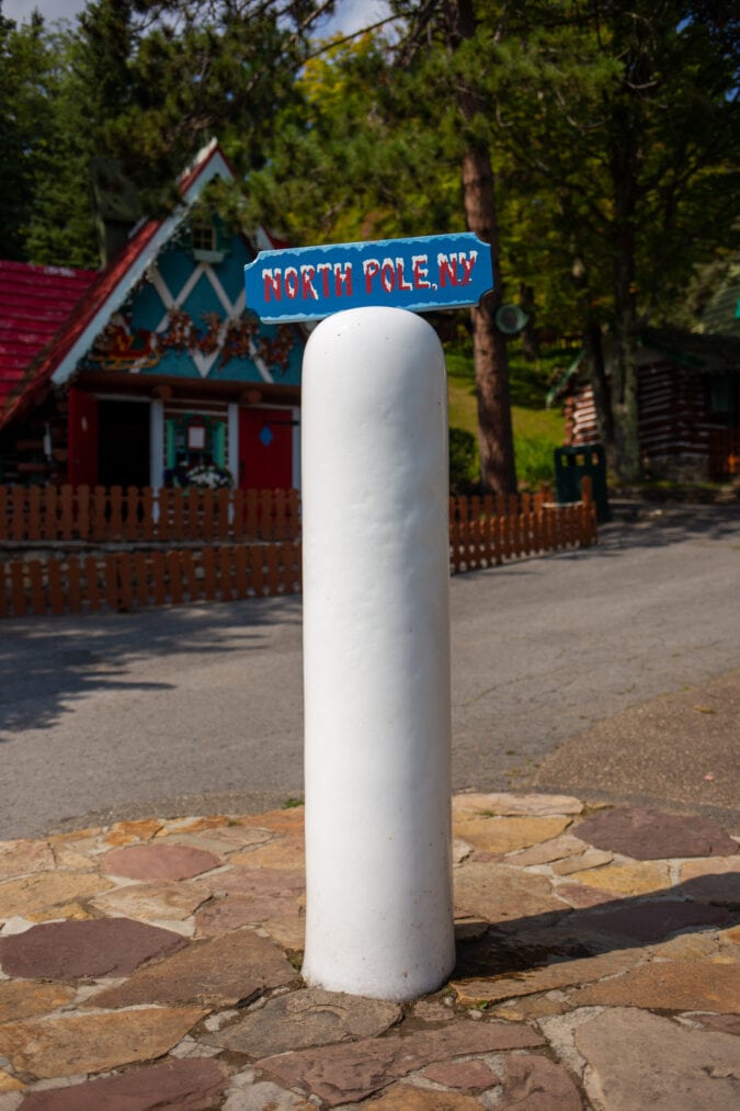 a white, icy north pole in the middle of an outdoor theme park