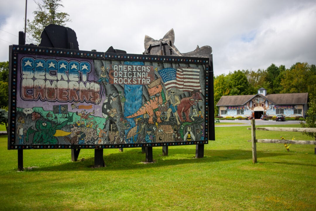 an intricately colorful handpainted billboard for secret caverns