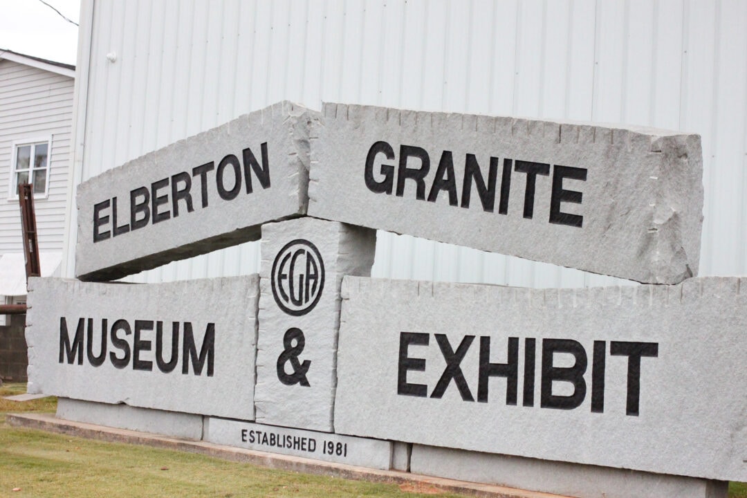 White granite slabs are stacked up to read "Elberton Granite Museum & Exhibit."