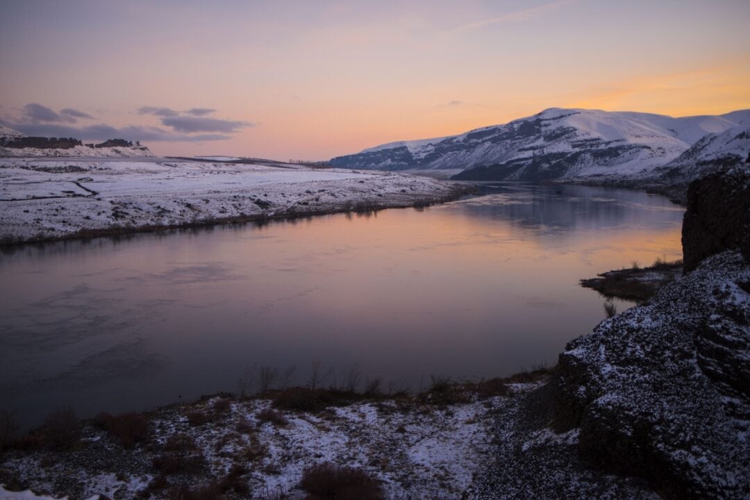 Blue and purple hues reflect off the surface of the Columbia River in winter.