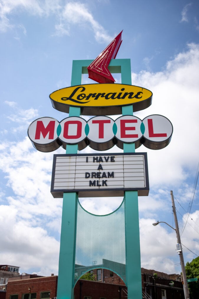 a yellow, teal and red neon sign for the lorraine motel