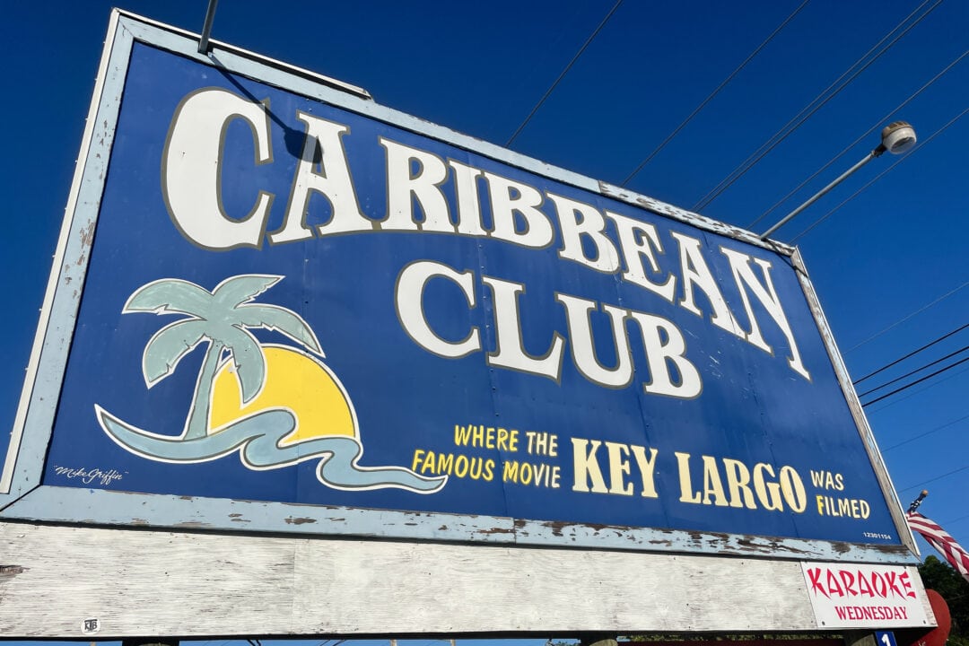 A blue sign reads "Caribbean Club, where the famous movie 'Key Largo' was filmed."
