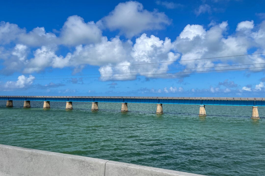 A side view of the Overseas Highway showcases the large stretch of ocean on either side of the road.