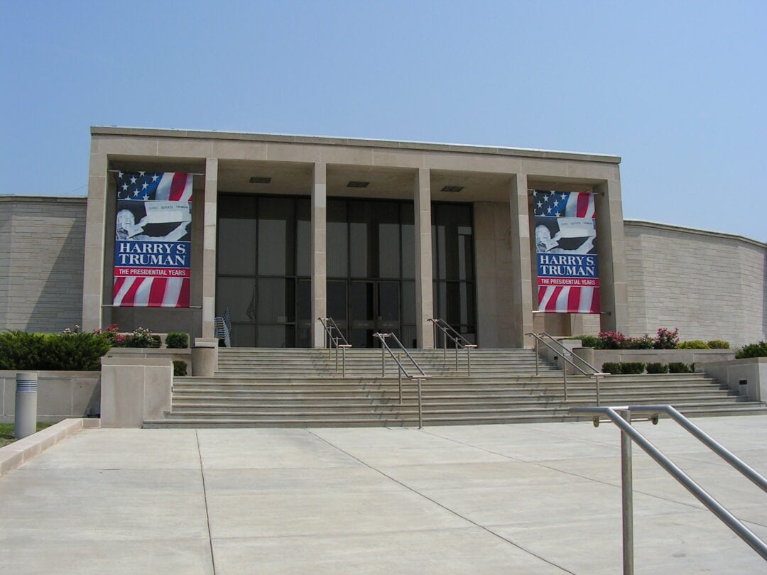Banners hang from the glass-front entrance of the Truman Presidential Library.
