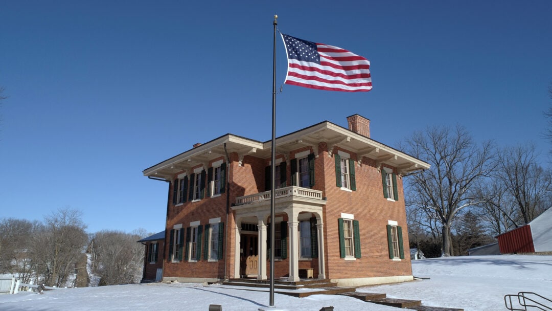 General Ulysses S. Grant's home is an Italianate-style home covered in brick with an American flag out front.