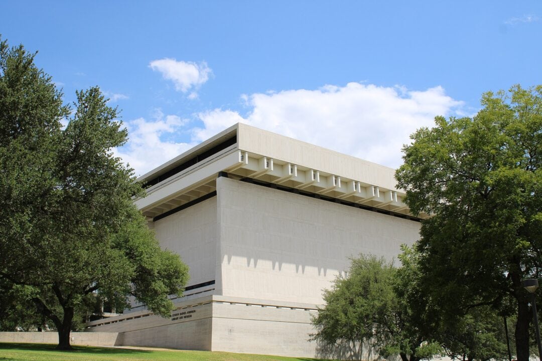 A stark white building houses the Lyndon B Johnson Presidential Library.