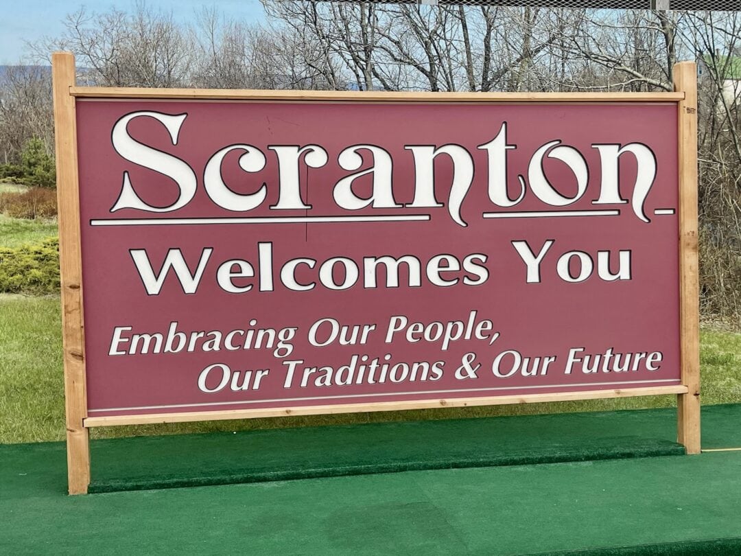 A large red sign reads "Scranton Welcomes You. Embracing our people, our traditions & our future."