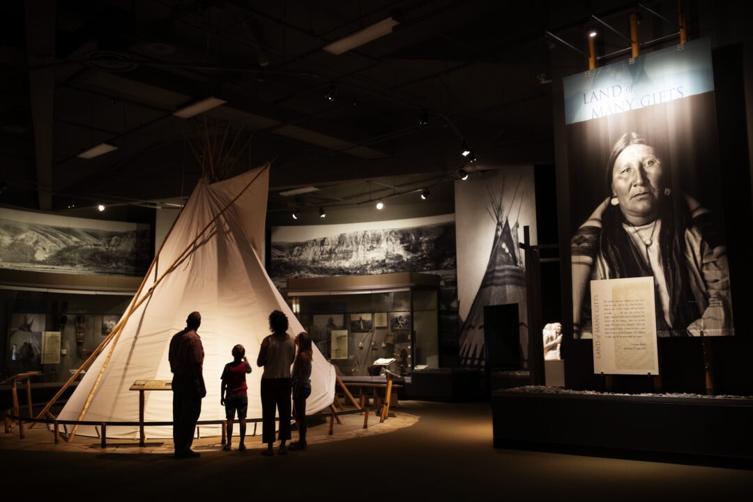The interior of the dimly lit Buffalo Bill Center is full of large displays of indigenous artifacts.