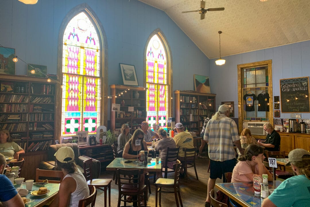 Stained glass windows inside a restaurant reveal that it was formerly used as a church