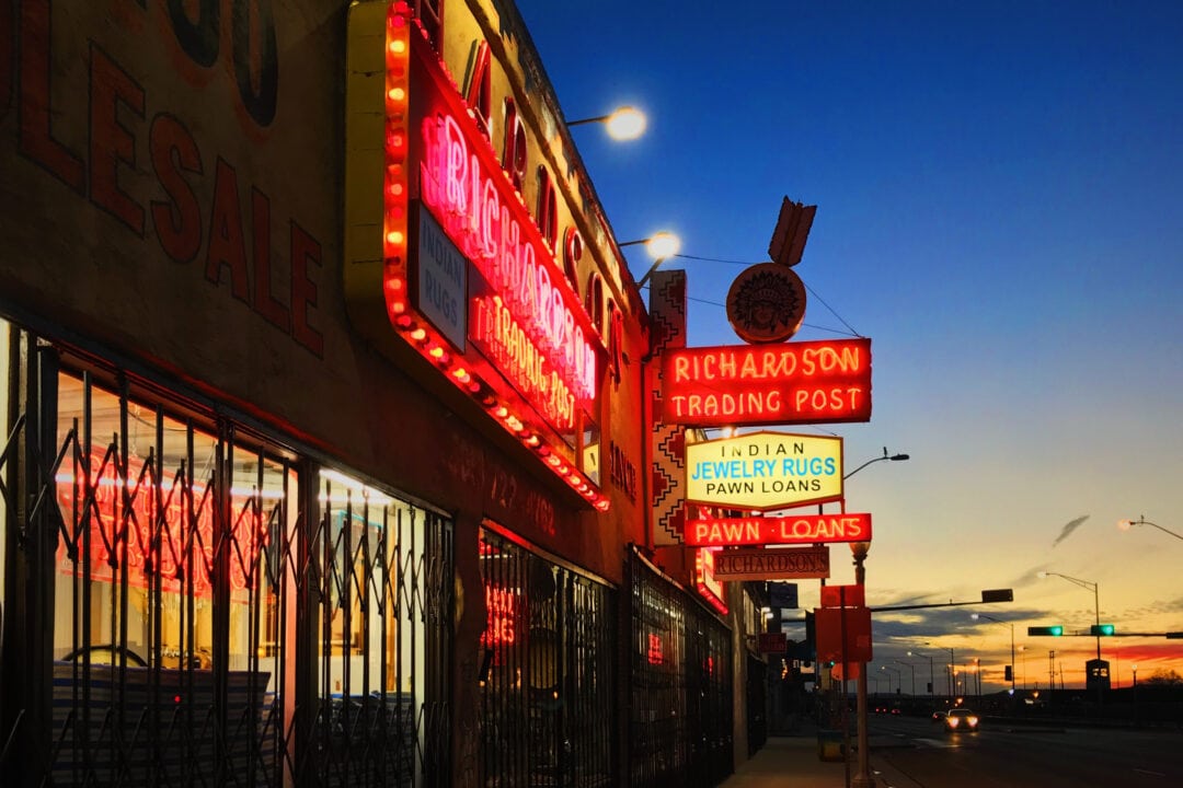 Bright neon signs illuminate a small Route 66 town in New Mexico