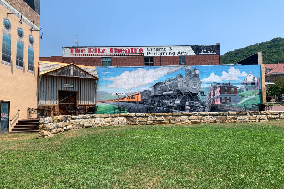 A sprawling train mural covers the side of a building