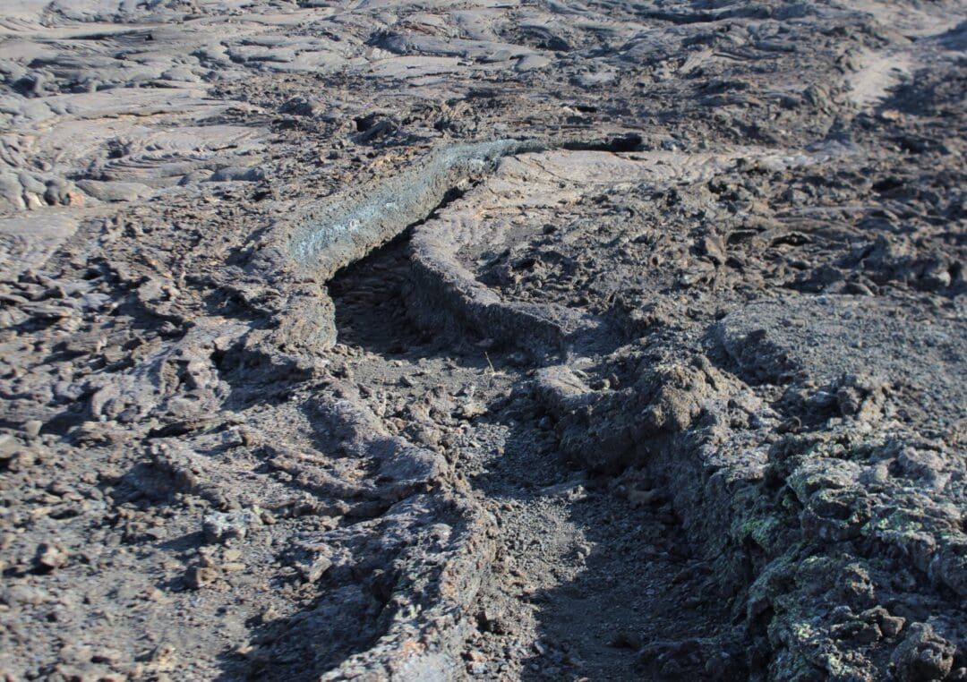 Collapsed lava tubes can be seen carving odd, smooth trails through the rocks.