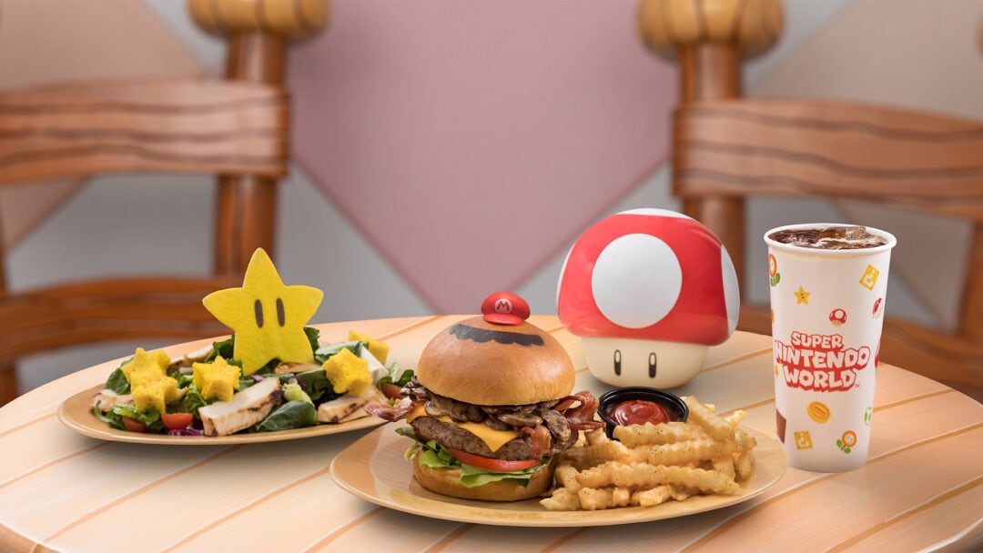 Cutesy food items themed to the world of Super Mario include a salad topped with a large star crouton, a burger with a mustache, and more