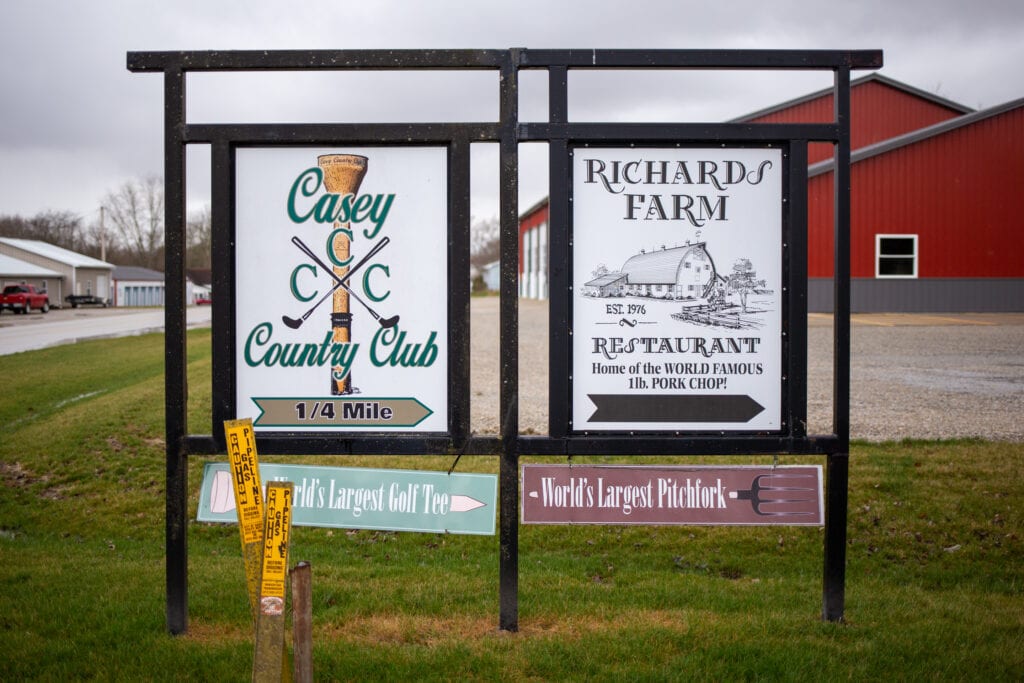 directional signage for a country club and a farm restaurant