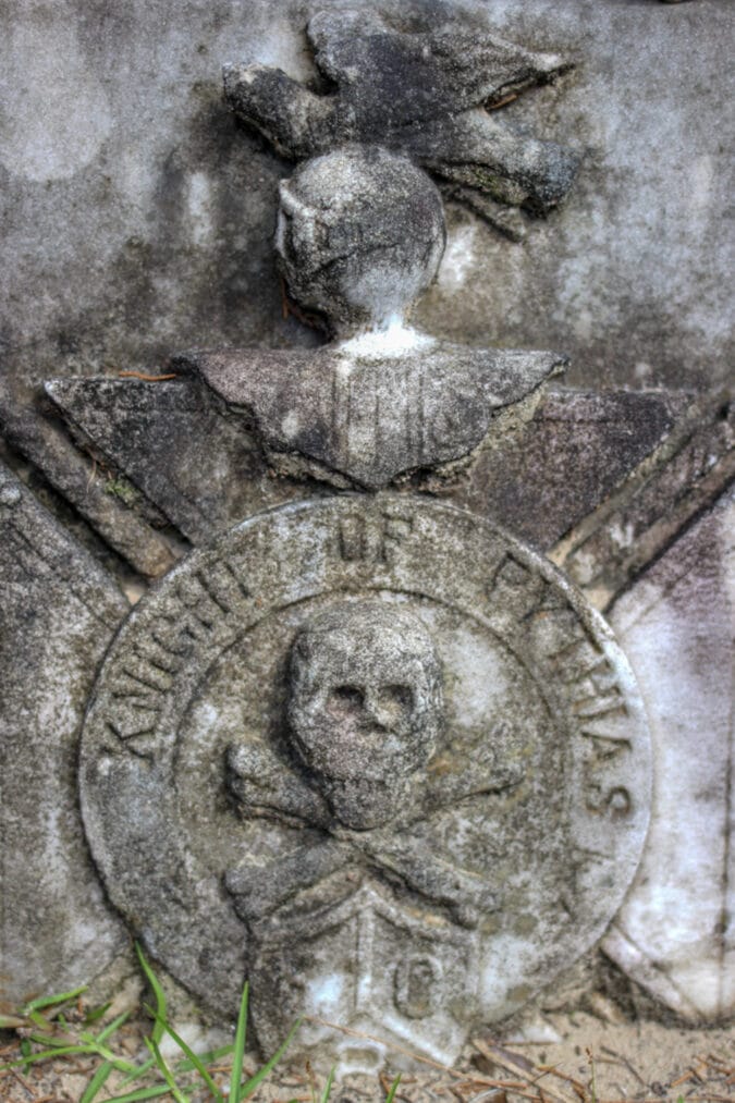 close up on a tombstone featuring a skull and crossbones